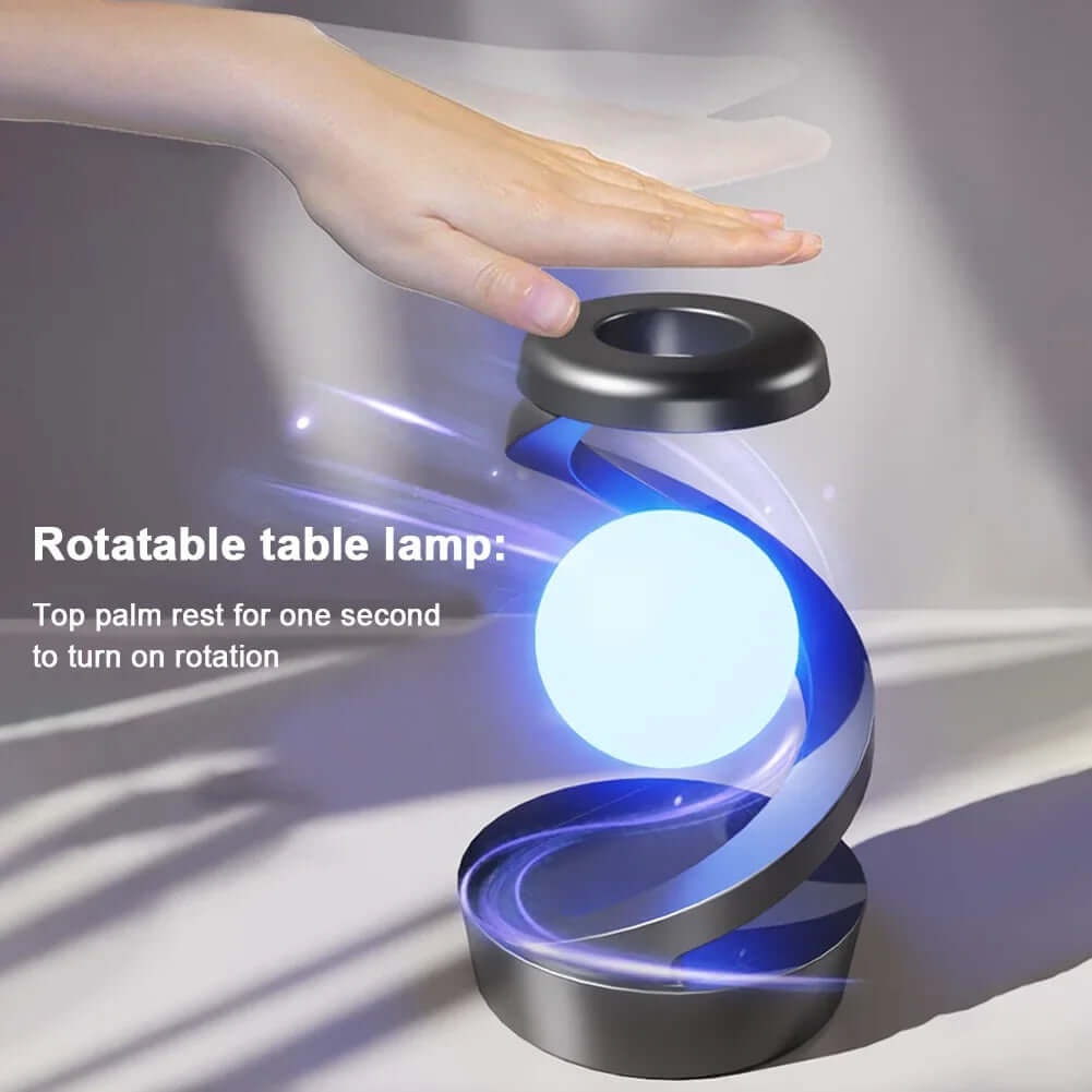 Levitating Ball Lamp with Wireless Charger in action with a hand engaging its rotatable feature.