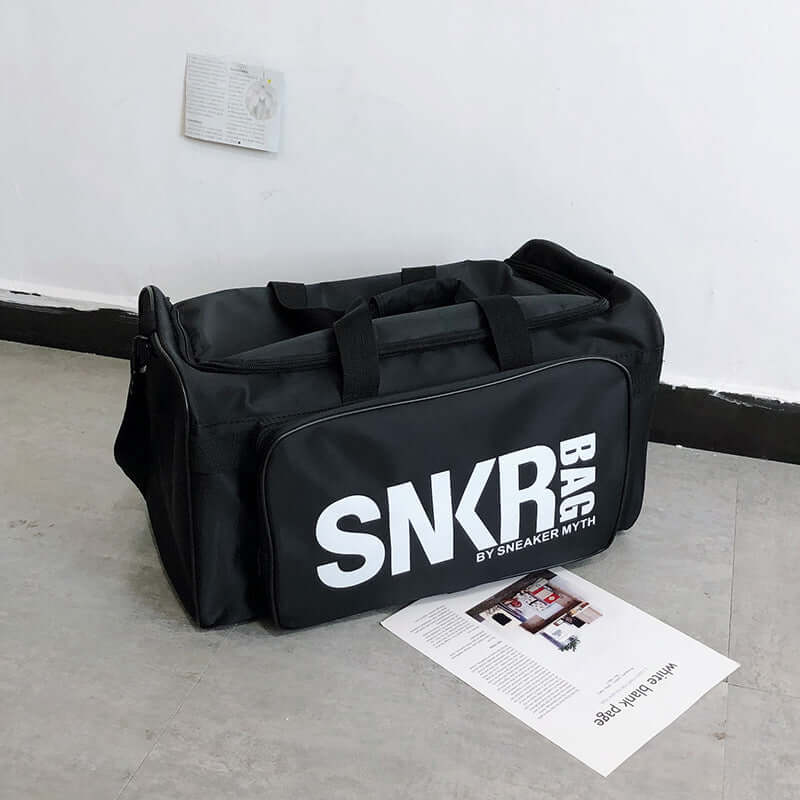 Ultimate Sports Bag for Athletes- Organize your Gear - black sports bag displayed on a floor.